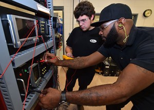 Edgecombe Community College is one of five colleges nationally to be recognized as a leader in manufacturing education. Shown from left are manufacturing technology students Josh Sears and Chad Cherry.