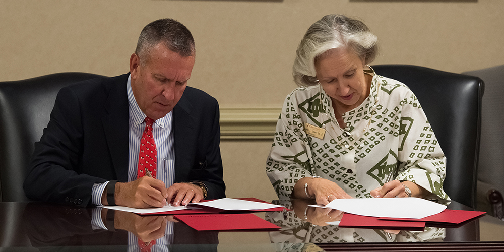 Dr. Dewey Clark and Dr. Deborah Lamm sign agreements