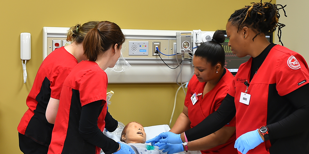 Edgecombe Community College nursing students assess and treat a patient simulator. The Cannon Foundation recently awarded $63,000 to the college to purchase a human trauma patient simulator that will be used primarily in first responder training.