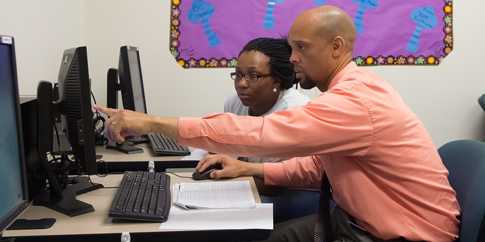 Sherrod Sumner, coordinator of the Student Success Center on the Tarboro campus, helps Shatyra Barnes register for spring classes at Edgecombe Community College. Student Success Centers have been established on both campuses thanks to a $2 million grant from the U.S. Department of Education Predominantly Black Institutions Program.