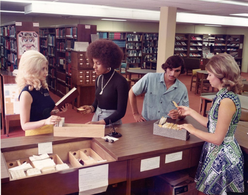 Photo: Library Director Sharon Deal assists students and staff in the old prison building in the 1970s. The library and Learning Resource Center were relocated to a new facility, Building C, in 1990.