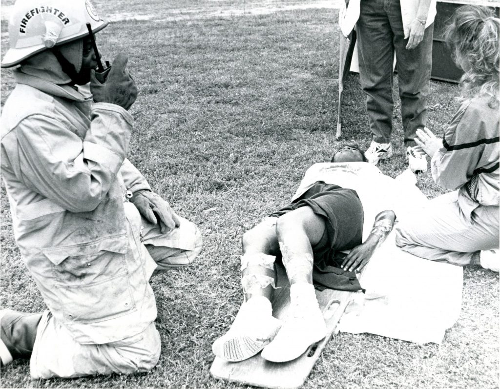 Photo: In a photo from the May 1999 disaster drill exercises, a second-year nursing student practices her skills in triage on a first-year nursing student. In mid-September, Hurricane Floyd, the second hurricane in a month, hit Edgecombe County with a power hitherto unknown in the recorded history of the region.