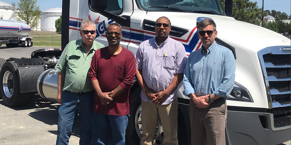 From left are Curt Odem, senior field maintenance manager at Eagle Transport; ECC students Brad Armstrong and Andre Kearney; and Lance Collette, president of Eagle Transport